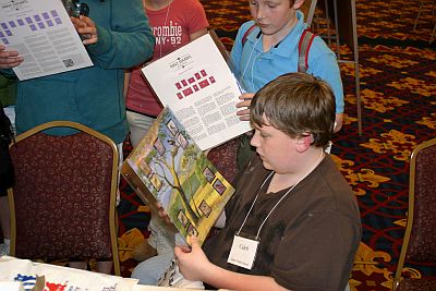 Boys looking at stamp items for sale at the show