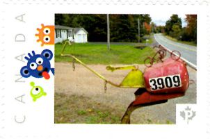 Picture Postage stamp showing folk art mailbox with a bicycle model on top