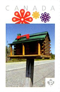 Picture Postage stamp showing folk art mailbox shaped as a log cabin