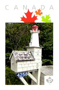 Picture Postage stamp showing folk art mailbox shaped as a lighthouse