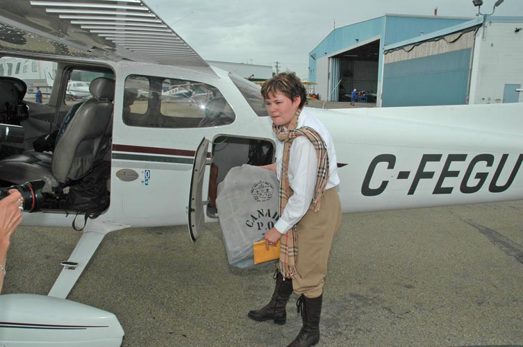 Audrey retrieving the mail bag from her aircraft