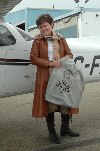 Audrey in her replica costume, holding the mail bag