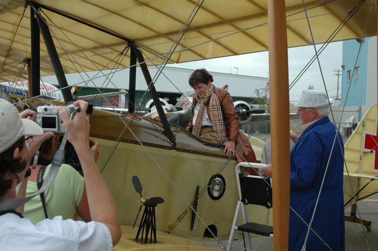 Audrey climbing into the replica aircraft
