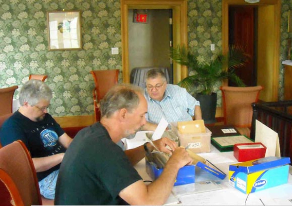 Clockwise around the table: Nick Poppenk
                (foreground), Rob Leigh, Larry Cerns