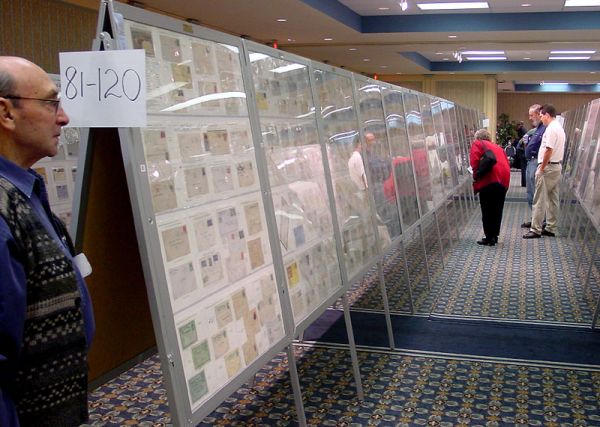 Ronald Battersby at left is 'guarding' the Newfoundland exhibits at PIPEX 2002